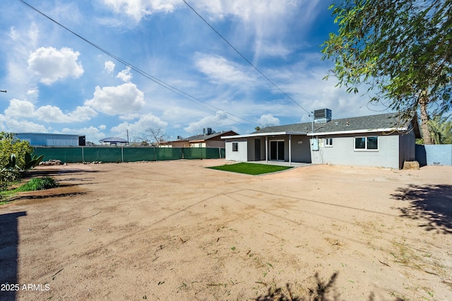 back of property with a patio and central AC