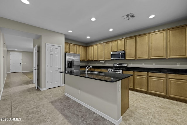 1953 E Lafayette Ave, Gilbert, AZ 85298 - kitchen with appliances with stainless steel finishes, recessed lighting, a kitchen island with sink, dark stone countertops, and light tile patterned floors