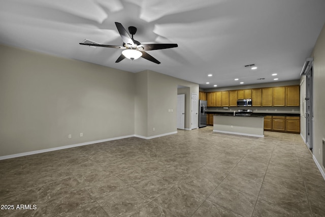 1953 E Lafayette Ave, Gilbert, AZ 85298 - kitchen with stainless steel appliances, dark countertops, open floor plan, recessed lighting, and brown cabinetry