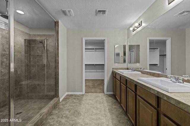 1953 E Lafayette Ave, Gilbert, AZ 85298 - bathroom with a spacious closet, double vanity, a shower stall, and tile patterned flooring