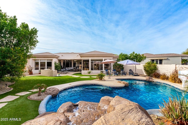 view of pool with a patio and a lawn