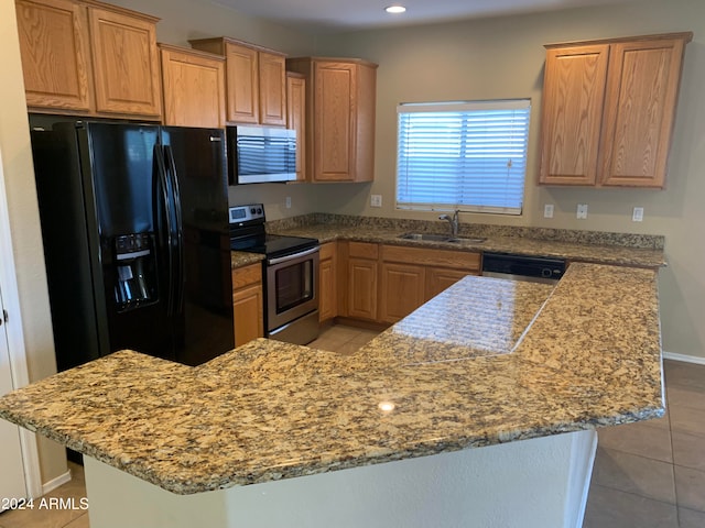 kitchen with sink, stainless steel appliances, light tile patterned floors, and a kitchen island