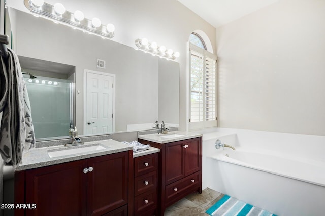 bathroom with a tub to relax in and vanity