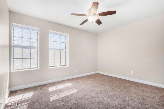 carpeted empty room featuring ceiling fan