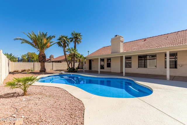 view of pool featuring a diving board and a patio