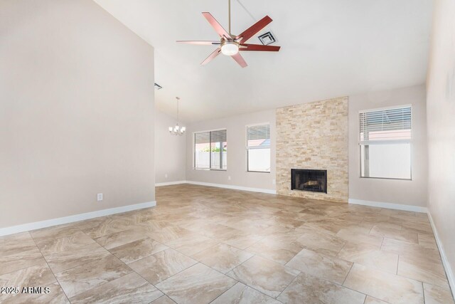 unfurnished living room with high vaulted ceiling, a fireplace, and ceiling fan with notable chandelier