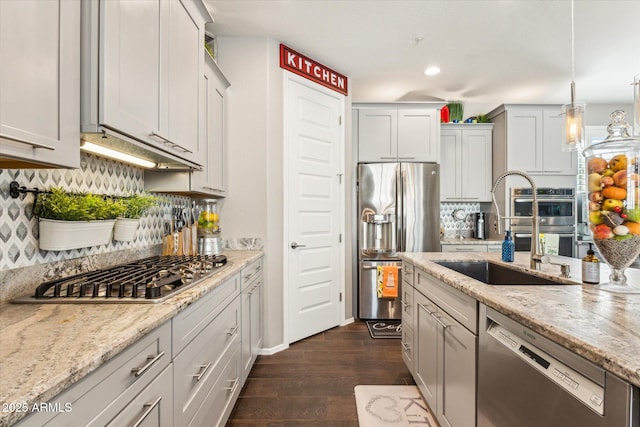 13088 N 91st Dr, Peoria, AZ 85381 - kitchen with appliances with stainless steel finishes, dark wood-style floors, tasteful backsplash, light stone countertops, and recessed lighting