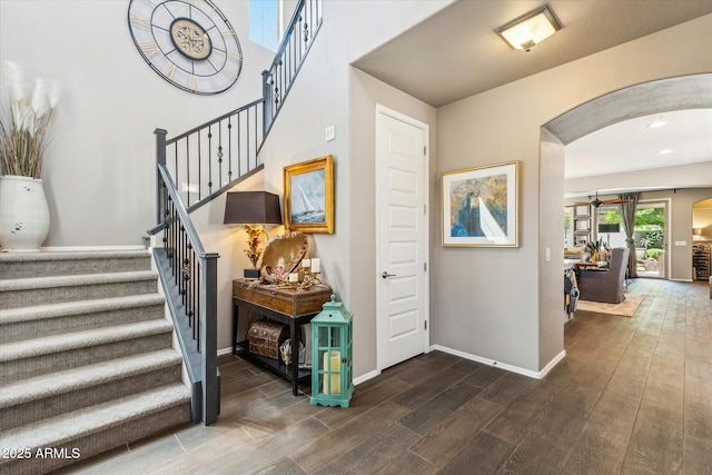 13088 N 91st Dr, Peoria, AZ 85381 - foyer entrance featuring arched walkways, wood finished floors, a ceiling fan, and stairs