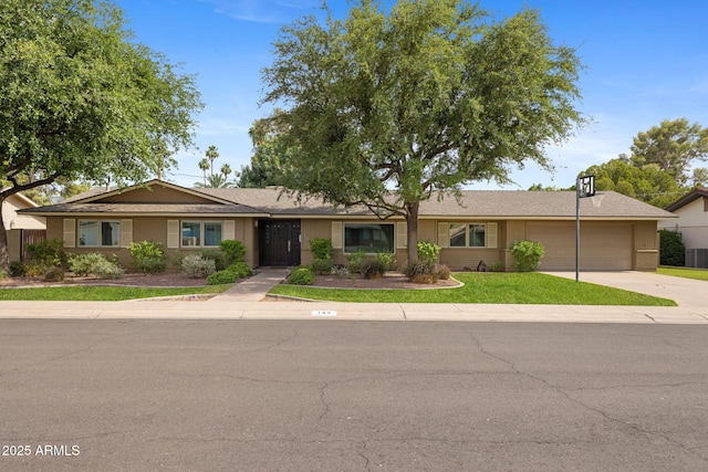 143 E Winter Dr, Phoenix, AZ 85020 - ranch-style house featuring an attached garage, concrete driveway, and central AC unit