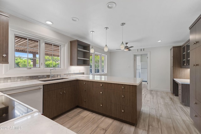 143 E Winter Dr, Phoenix, AZ 85020 - kitchen featuring a sink, light countertops, crown molding, a peninsula, and wood tiled floors