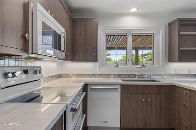 143 E Winter Dr, Phoenix, AZ 85020 - kitchen with white appliances, a sink, light countertops, tasteful backsplash, and crown molding