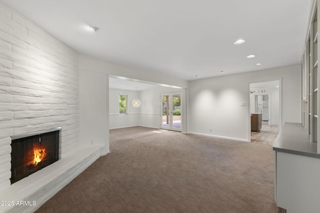 143 E Winter Dr, Phoenix, AZ 85020 - unfurnished living room featuring a fireplace, light colored carpet, baseboards, and recessed lighting