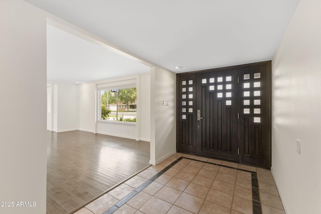 143 E Winter Dr, Phoenix, AZ 85020 - entryway featuring baseboards, inlaid floor details, and tile patterned flooring