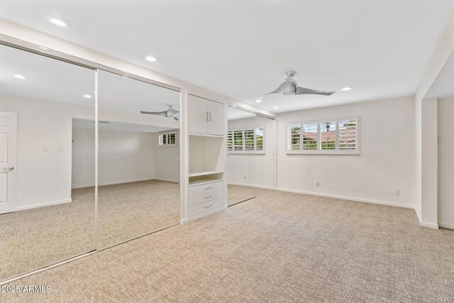 143 E Winter Dr, Phoenix, AZ 85020 - unfurnished bedroom featuring light colored carpet, recessed lighting, a ceiling fan, multiple closets, and baseboards