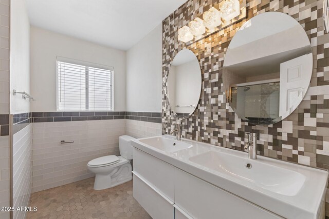 143 E Winter Dr, Phoenix, AZ 85020 - bathroom with tile walls, toilet, tile patterned flooring, a stall shower, and double vanity