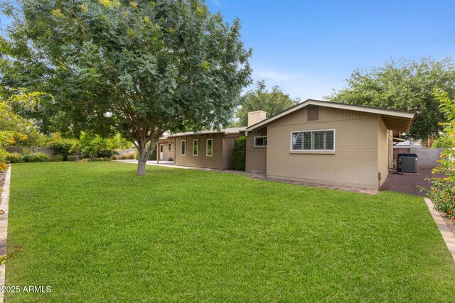 143 E Winter Dr, Phoenix, AZ 85020 - back of house featuring central air condition unit and a chimney