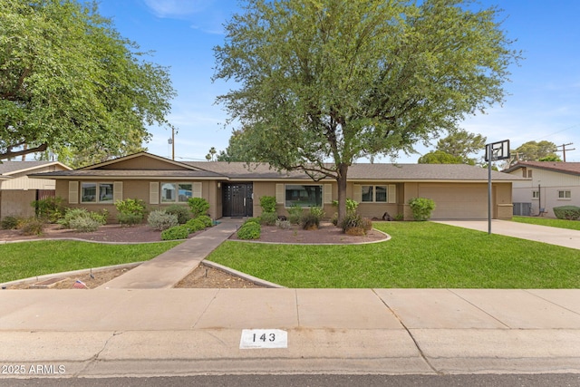 143 E Winter Dr, Phoenix, AZ 85020 - ranch-style home with an attached garage, concrete driveway, a front lawn, and central air condition unit
