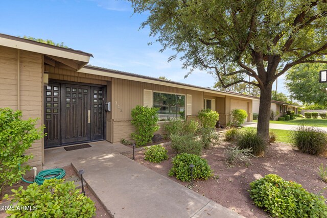 143 E Winter Dr, Phoenix, AZ 85020 - view of exterior entry with an attached garage