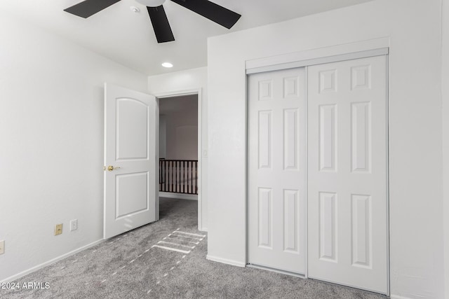 unfurnished bedroom with carpet flooring, a closet, and ceiling fan