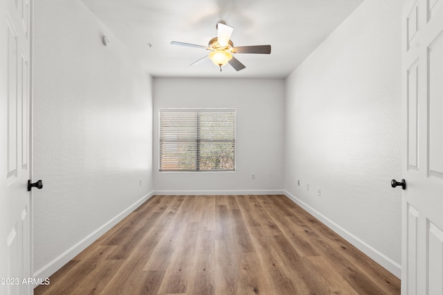 spare room featuring ceiling fan and hardwood / wood-style flooring