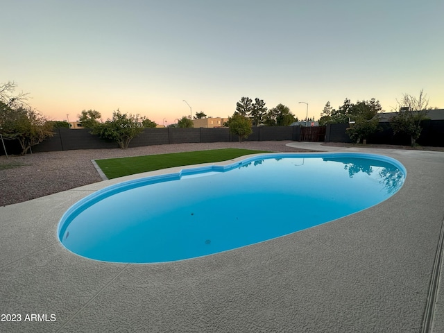 view of pool at dusk