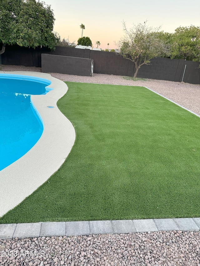 view of pool at dusk