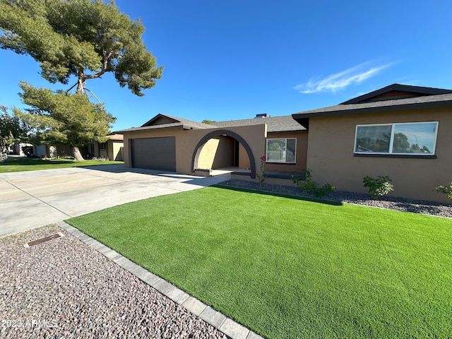 single story home with a garage and a front lawn