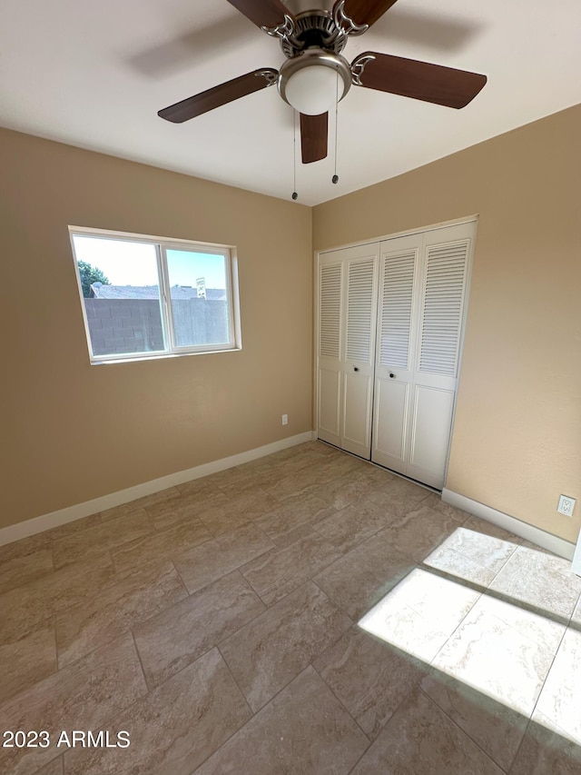 unfurnished bedroom with ceiling fan, a closet, and light tile floors