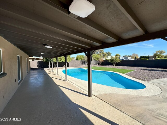 view of swimming pool with a patio area