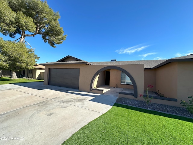 single story home with a front lawn and a garage