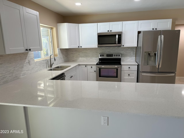 kitchen with appliances with stainless steel finishes, tasteful backsplash, and light stone counters