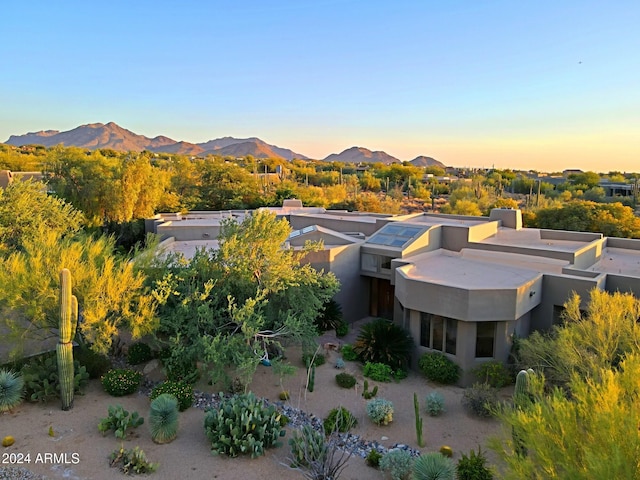 aerial view at dusk featuring a mountain view