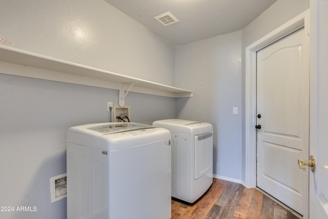 clothes washing area with independent washer and dryer and dark hardwood / wood-style floors