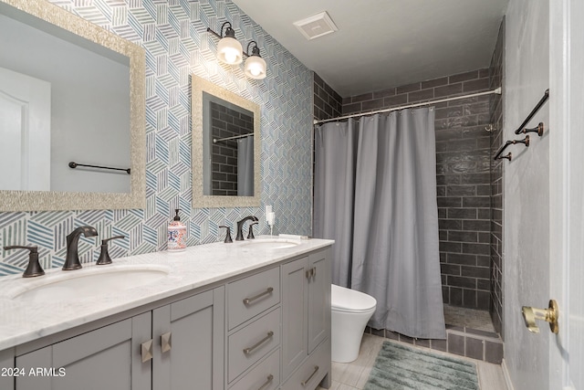 bathroom with double sink vanity, toilet, tile patterned flooring, a shower with curtain, and backsplash