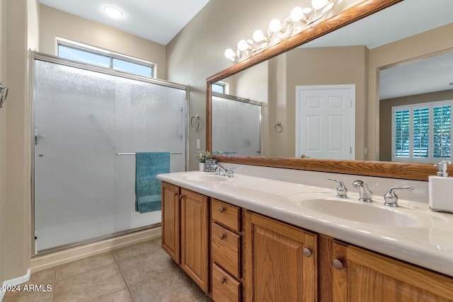 bathroom featuring vanity, tile patterned floors, and a shower with shower door