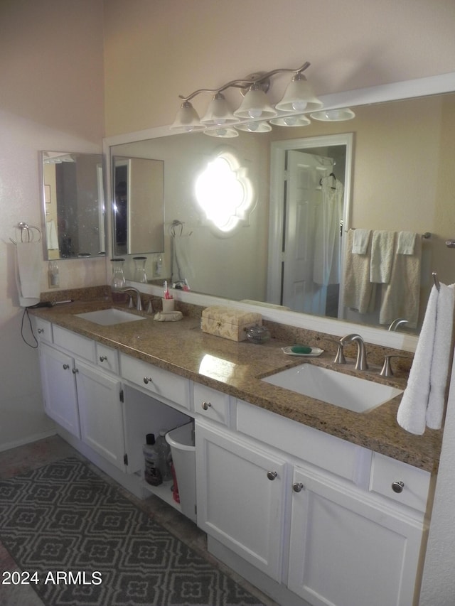 bathroom with walk in shower and vanity