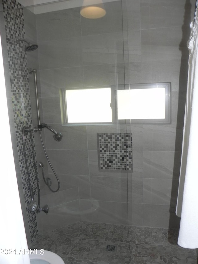 bathroom with toilet and an enclosed shower