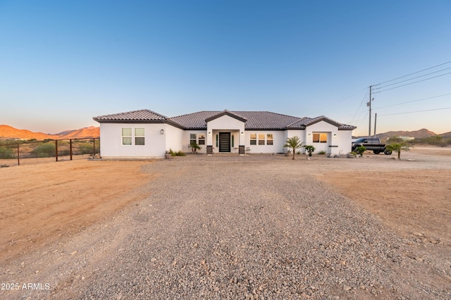 8017 S 143rd Ave, Goodyear, AZ 85338 - mediterranean / spanish-style home with a tile roof, stucco siding, and a mountain view