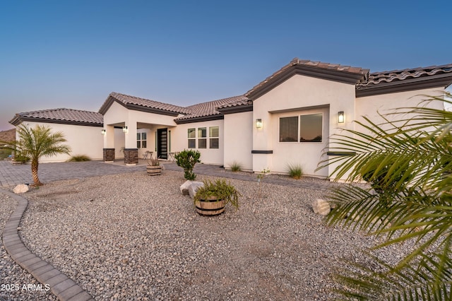 8017 S 143rd Ave, Goodyear, AZ 85338 - mediterranean / spanish house with stucco siding, a tiled roof, and a patio