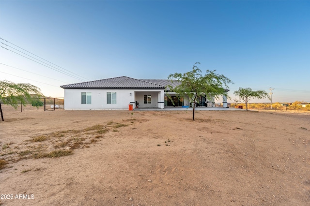 8017 S 143rd Ave, Goodyear, AZ 85338 - rear view of property with a tiled roof and stucco siding
