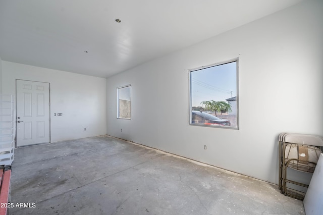 8017 S 143rd Ave, Goodyear, AZ 85338 - empty room with unfinished concrete floors and healthy amount of natural light