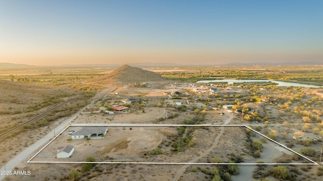 8017 S 143rd Ave, Goodyear, AZ 85338 - aerial view at dusk of property parcel outlined, a view of countryside, and a mountain view