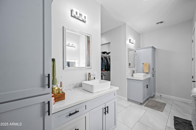 8017 S 143rd Ave, Goodyear, AZ 85338 - full bath with two vanities, marble finish flooring, and a spacious closet