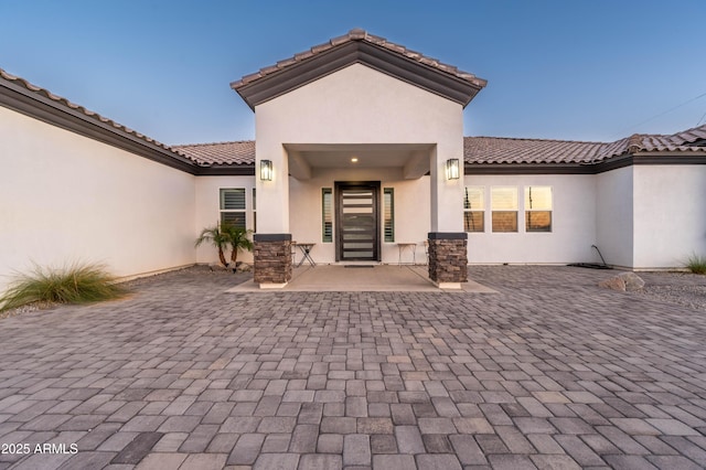 8017 S 143rd Ave, Goodyear, AZ 85338 - entrance to property with a patio area, stucco siding, and a tiled roof