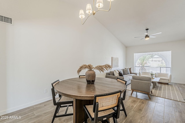 2307 W Nido Ave, Mesa, AZ 85202 - dining room with light wood finished floors, vaulted ceiling, a ceiling fan, baseboards, and a chandelier