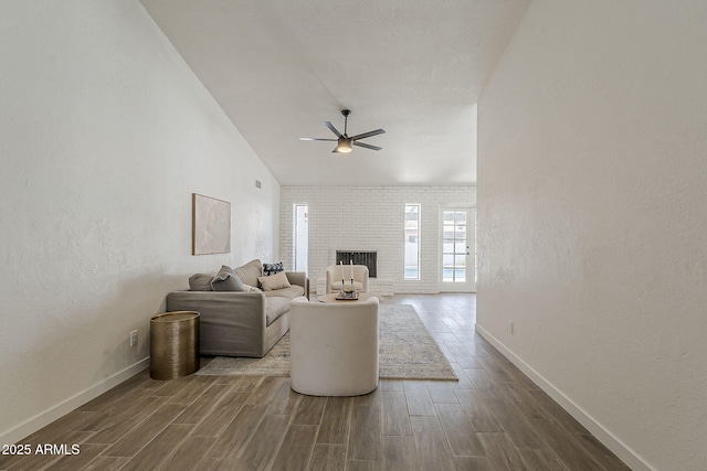 2307 W Nido Ave, Mesa, AZ 85202 - living area with a ceiling fan, dark wood finished floors, baseboards, a textured wall, and a fireplace