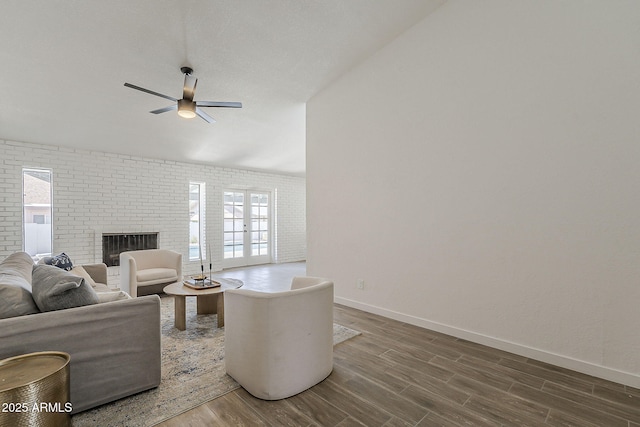 2307 W Nido Ave, Mesa, AZ 85202 - living area featuring a ceiling fan, dark wood-type flooring, baseboards, healthy amount of natural light, and brick wall