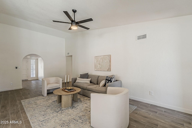 2307 W Nido Ave, Mesa, AZ 85202 - living room featuring arched walkways, a ceiling fan, baseboards, wood finished floors, and a towering ceiling