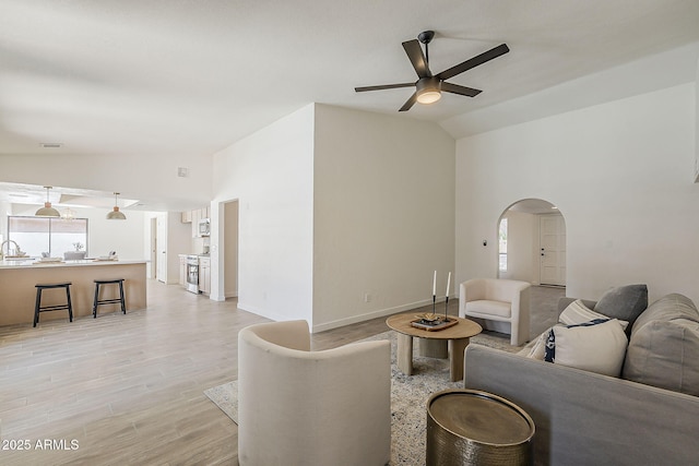 2307 W Nido Ave, Mesa, AZ 85202 - living area featuring lofted ceiling, a ceiling fan, arched walkways, light wood-style flooring, and baseboards