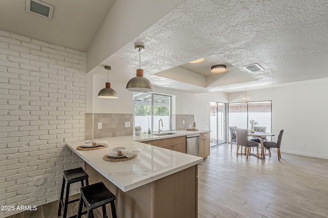 2307 W Nido Ave, Mesa, AZ 85202 - kitchen with stainless steel dishwasher, healthy amount of natural light, a sink, a chandelier, and a textured ceiling
